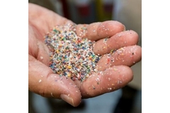 Image Plastic particles in hand.